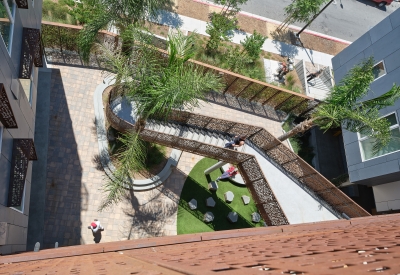Looking down at the entry courtyard to from the open-air stair at Sango Court.