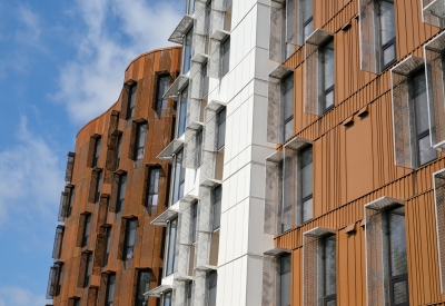 Detail view of the weathered steel facade of Africatown Plaza in Seattle.