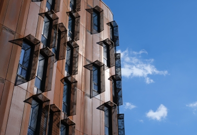 Detail view of the weathered steel facade of Africatown Plaza in Seattle.