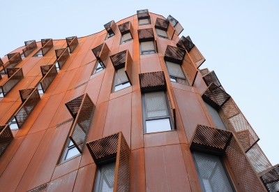 Detailed view of the weathered steel and windows at Africatown Plaza in Seattle.
