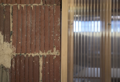 Detail of exposed terracotta and translucent double-walled polycarbonate panels at Wyatt Builds office. 