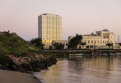 Exterior view of Isle House from the water at sunset.