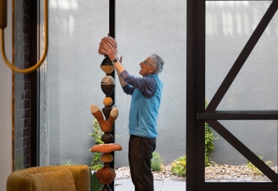 Man assembling a sculpture.