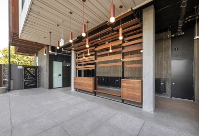 View of open-air lobby with lighting and mailboxes.