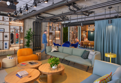 Lounge space with 2 sofas and 3 round tables with blue curtain and conference room in background