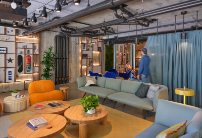 Lounge space with 2 sofas and 3 round tables with blue curtain and conference room in background