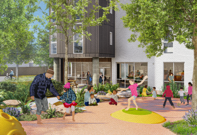 Children playing on paved ground in front of gray and white building