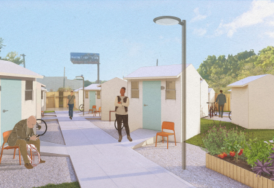 Man standing in front of small building