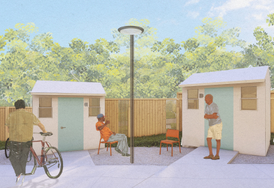 People standing in front of small buildings  