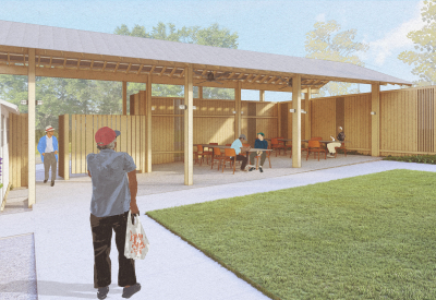 Person walking toward wood pavillion