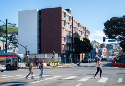 Apartment building in neighborhood context with pedestrians