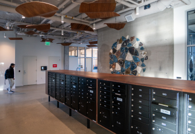 Common area with mailboxes, wood ceiling panels, and artful wall tiles