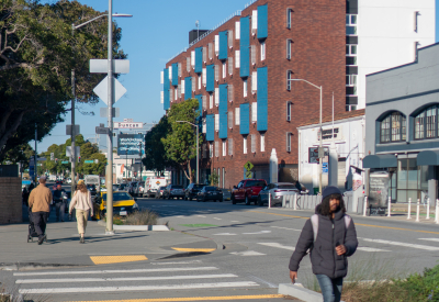 Apartment building in neighborhood context with pedestrians