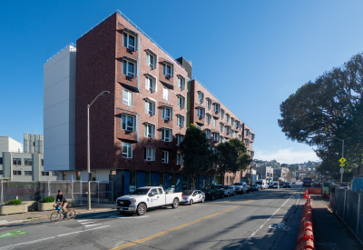 Street view of apartment on tree-lined street
