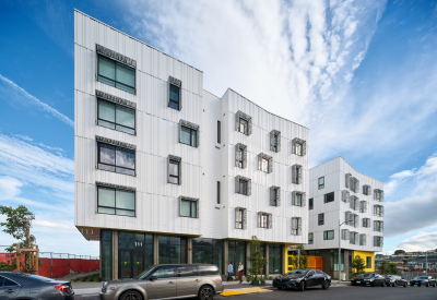 Street view of apartment building against blue sky