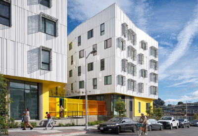 Oblique street view showing colorful ground floor entry area