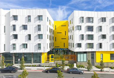 Aerial elevation of apartment building showing full yellow wall with narrow windows