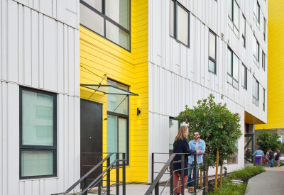 Two people chatting on a stoop 