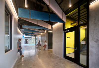 Interior hallway links stairwell, buildings, and courtyard