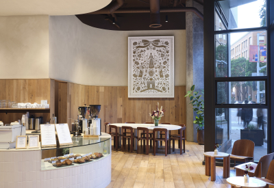 View of coffee shop with tables and window wall