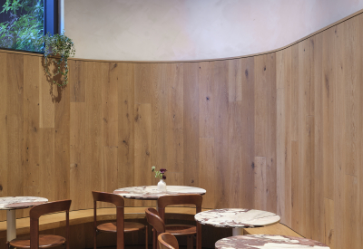 Bistro tables line a curved wall