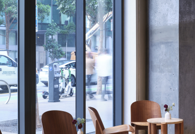 Floor to ceiling windows make up a wall of the coffee shop