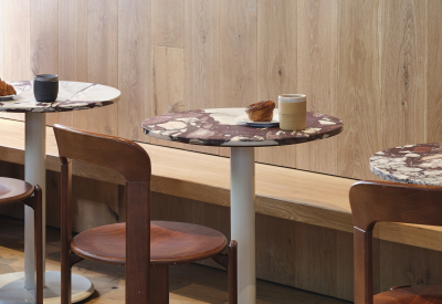 The light wood wall forms a banquette of seating