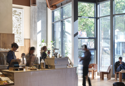 Coffee shop patrons enjoy the small, daylit shop