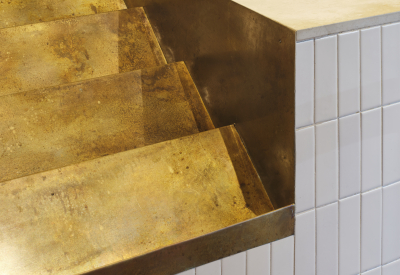 Detail of the cutout in the ordering counter: angled risers are build to hold bags of coffee beans and more