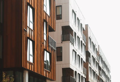 Rust and white building with sidewalk