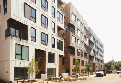 White and rust colored building along a street