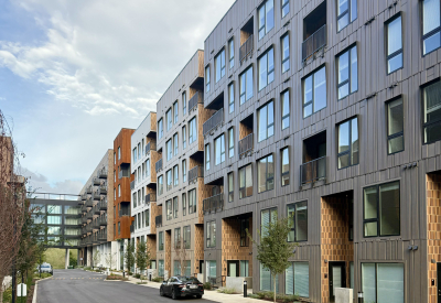 Large gray and rust building with crosswalk in background