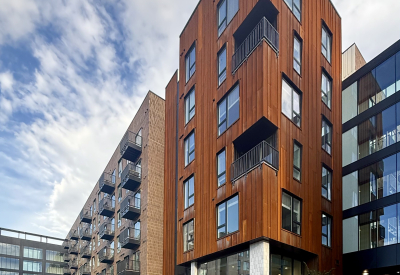Rust colored corner building with crosswalk in background