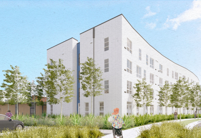 White building with blue and trees in foreground and blue sky background