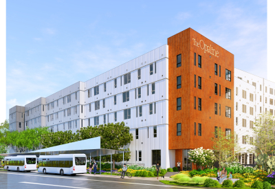 Orange building facade facing street with white building in background