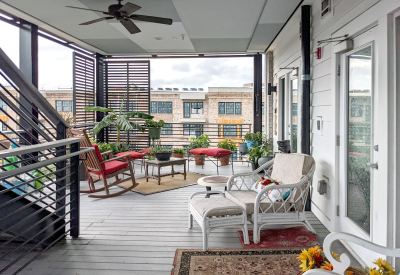 View of a covered porch with neatly arranged outdoor furniture