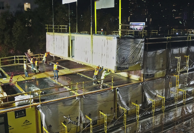 Modular construction night scene, crew placing a module