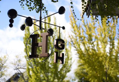 Detail of a hanging kinetic sculpture with the rotating letters H G and H