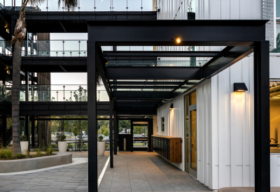 View from courtyard toward glass entry door of multfamily building