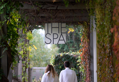 Two people in robes walking under sign that says "The Spa"