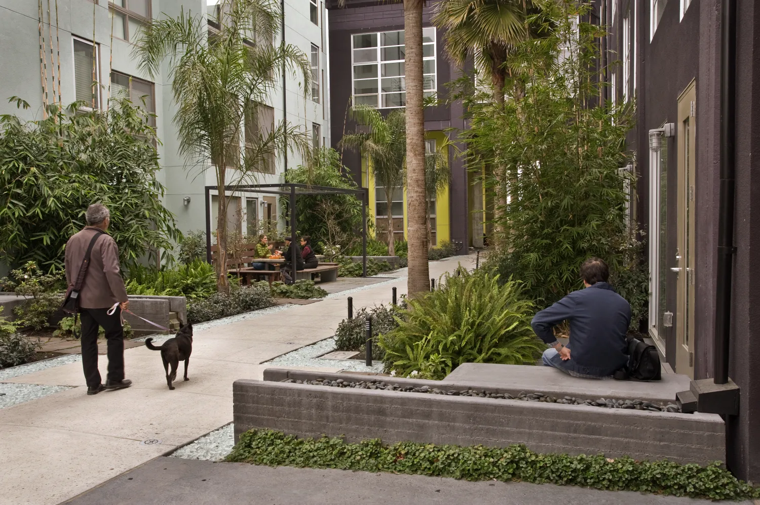 People hanging in a courtyard at Pacific Cannery Lofts in Oakland, California.