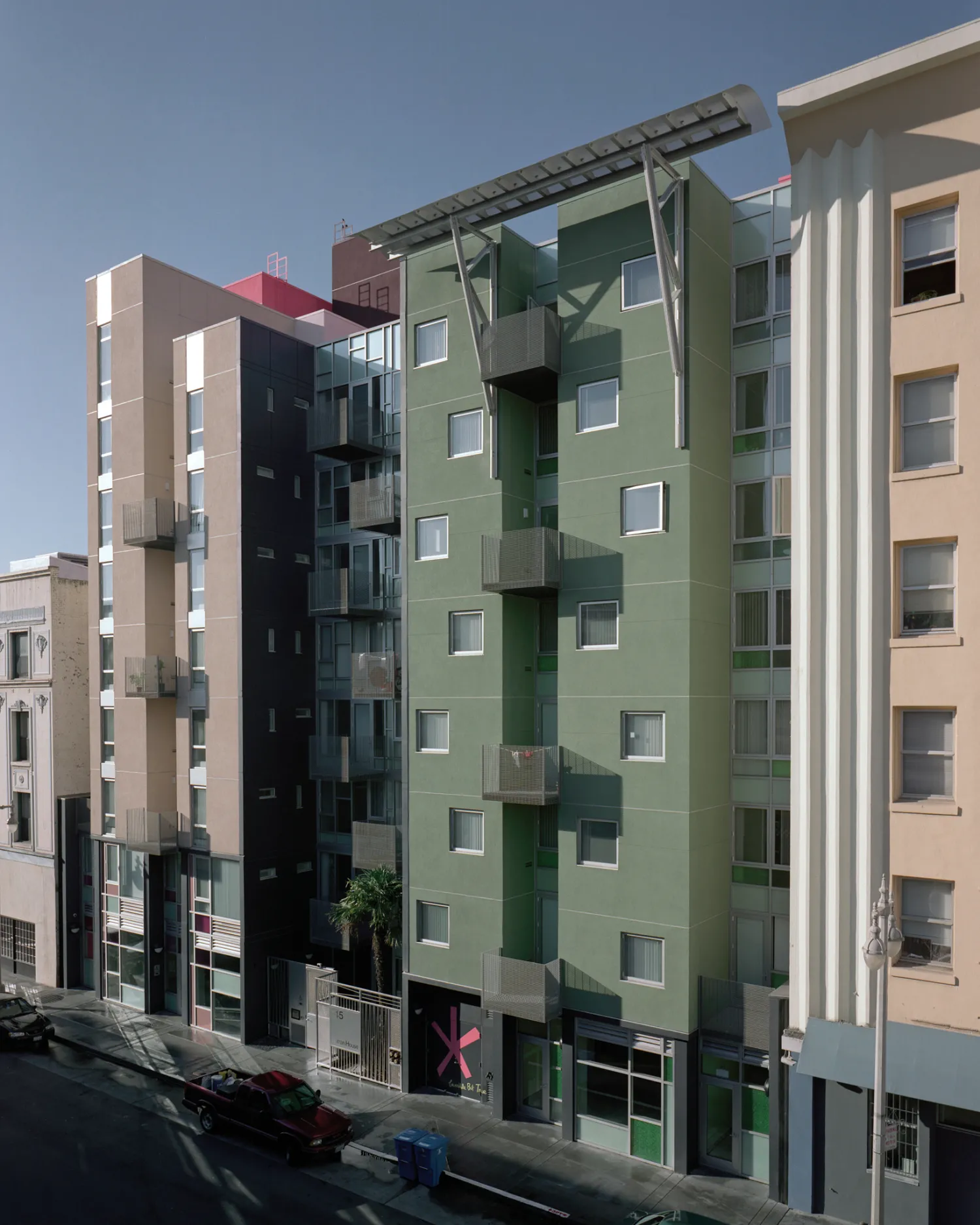 Curran House, an 8-story building in the Tenderloin, on a blue-sky day.