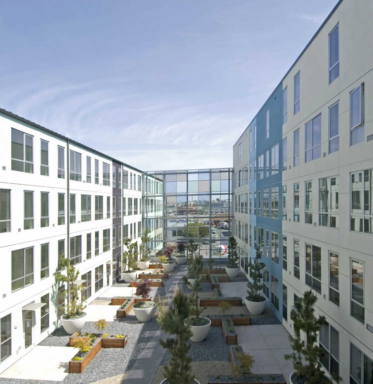 Residential courtyard with glass sound wall at 888 Seventh Street in San Francisco.