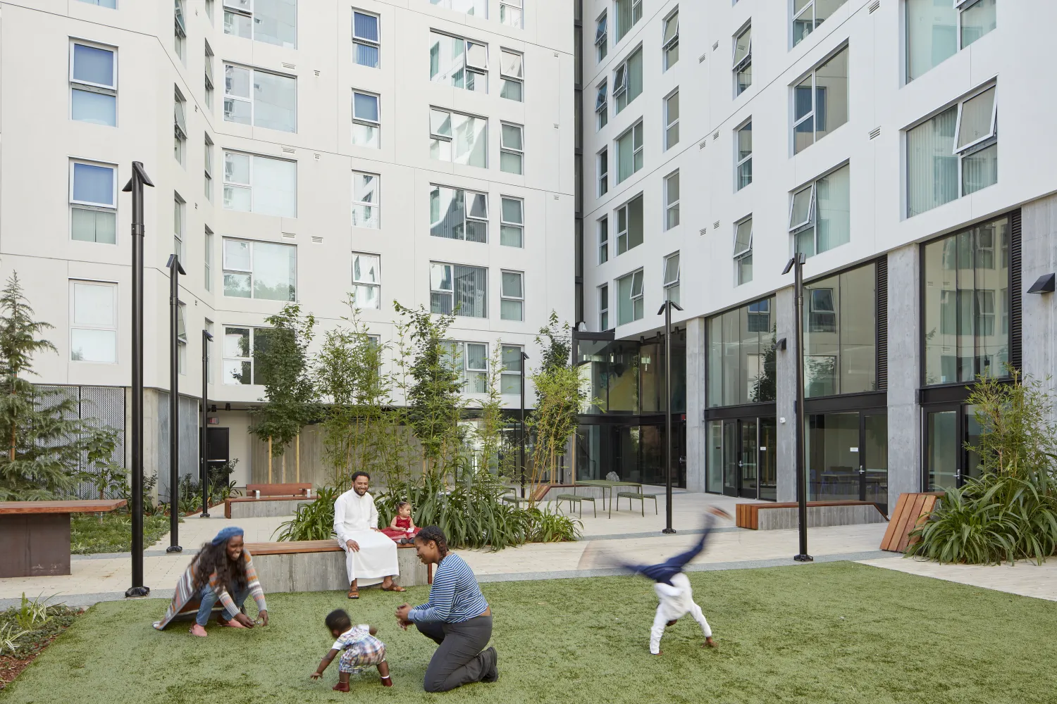Families playing in the Courtyard of 222 Taylor Street, affordable housing in San Francisco