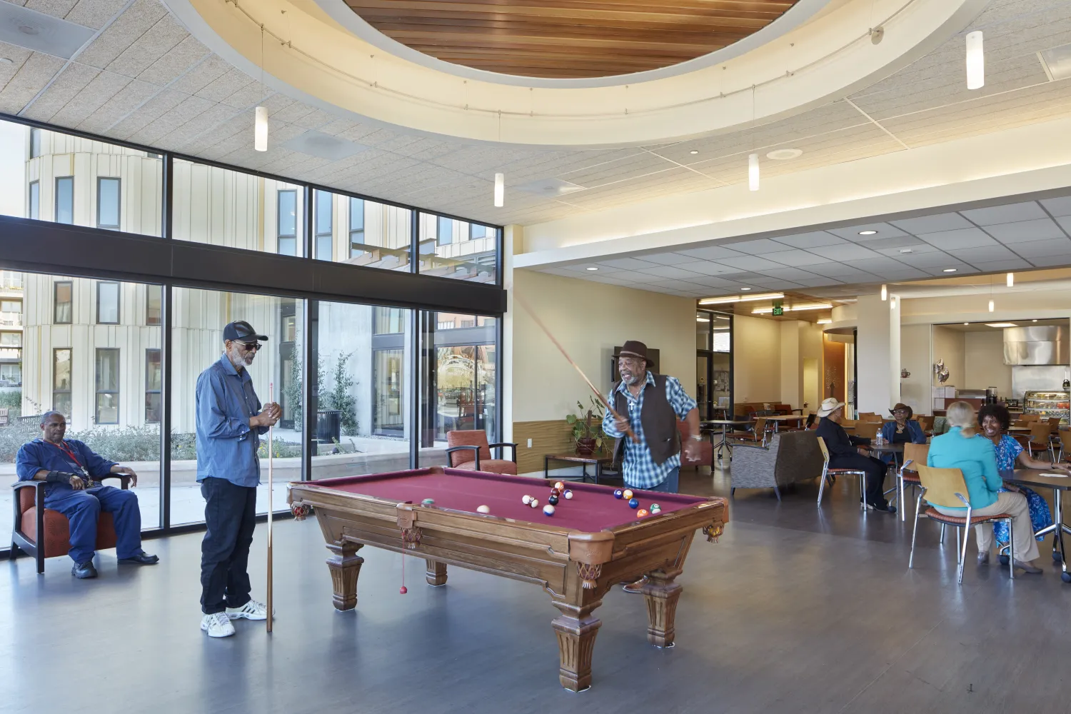 Residents playing pool at the Senior Center inside Dr. George Davis Senior Building in San Francisco.