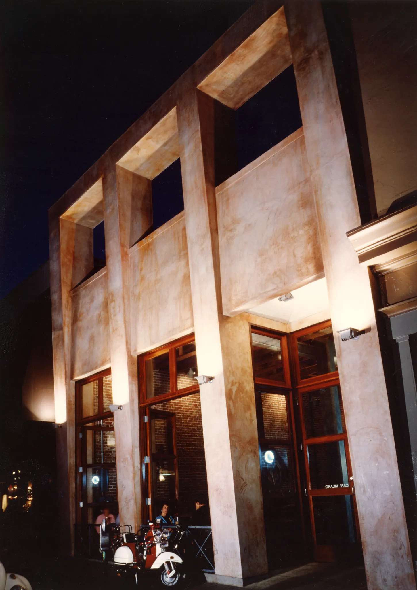 Exterior view of Cafe Milano at night in Berkeley, California.
