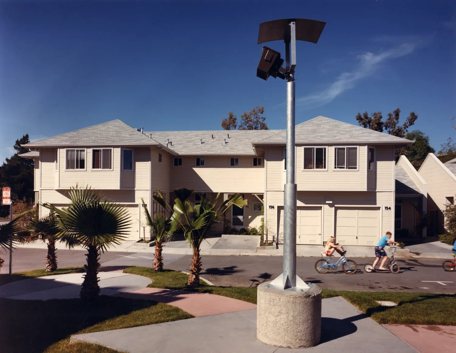 Exterior street view of two duplexs at Meadow Court in San Mateo, California.