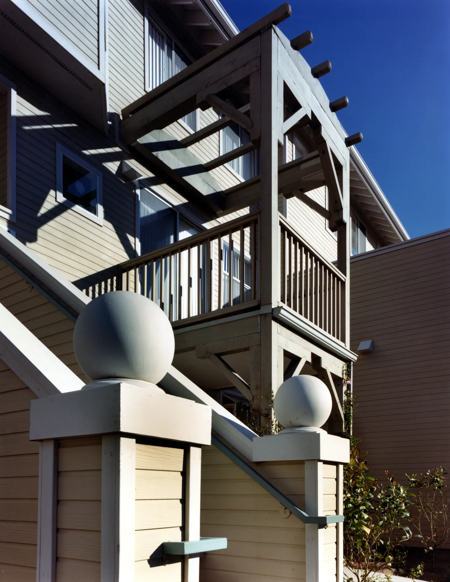 Exterior view of an entry stair and balcony at Meadow Court in San Mateo, California.
