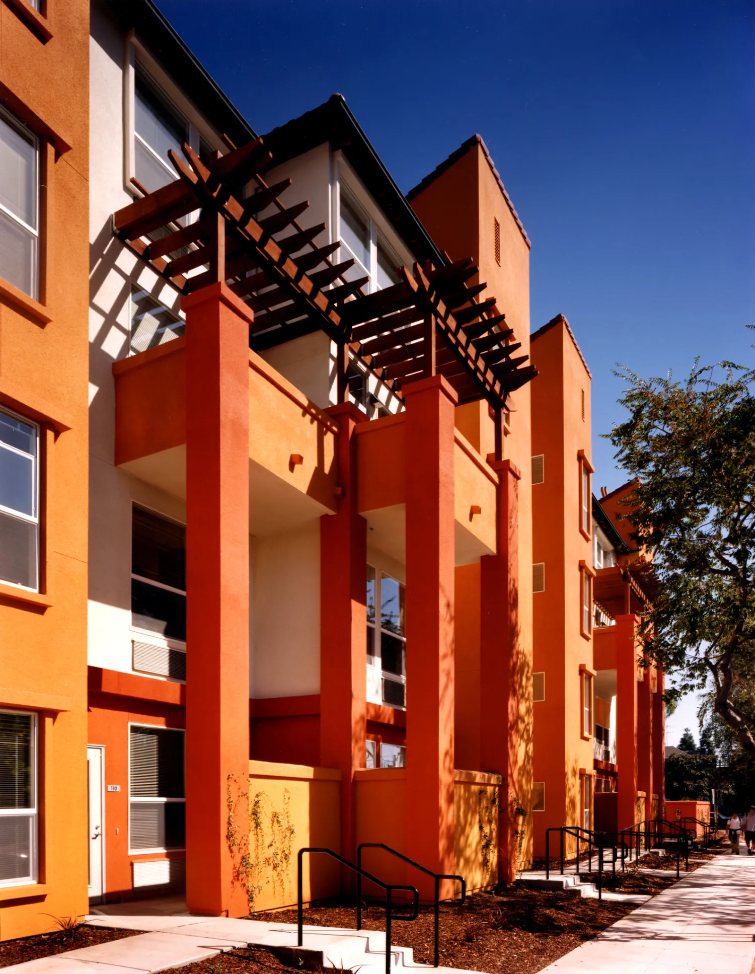 Sidewalk view of ground-level units at Plaza Maria in San Jose, California.