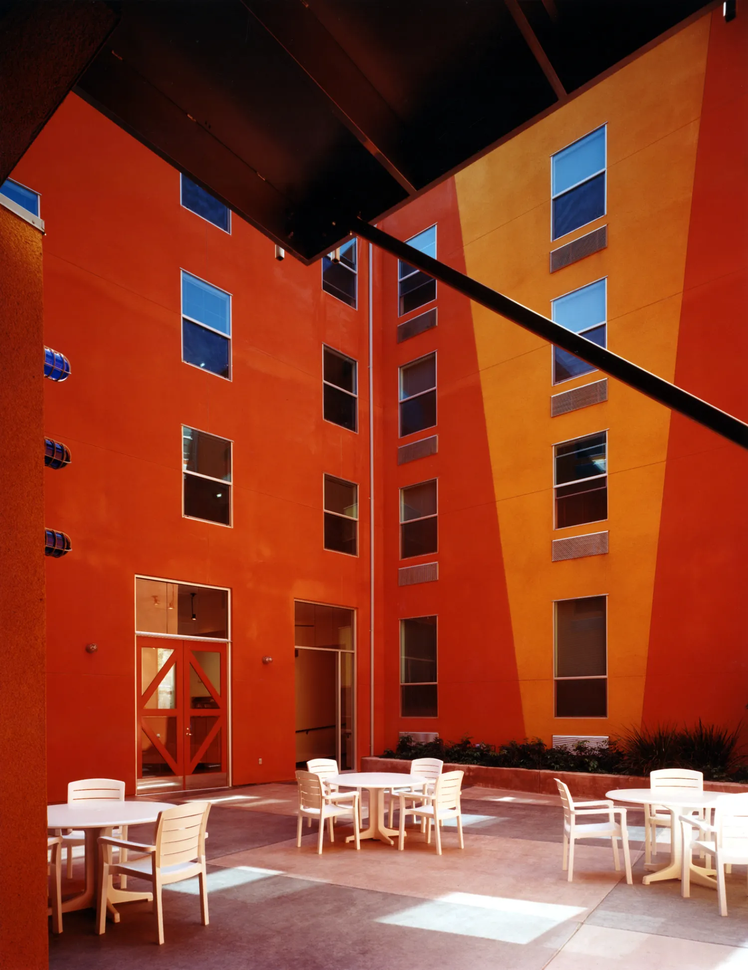 Resident courtyard with table and chairs at Pensione K in Sacramento, California.
